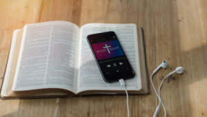 open bible with phone and headphones,Concept listen the words of
